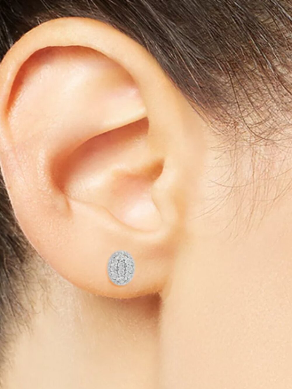 Beautiful oval-shaped stud earrings are set with sparkling diamonds in sterling